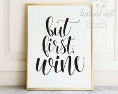 a black and white poster with the words but first wine on it next to a marble countertop