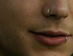 a man with nose piercings on his nose