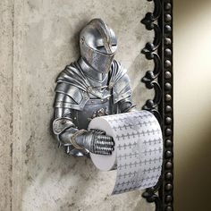 a knight is holding a roll of toilet paper in front of a wall mounted mirror