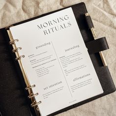 a black and white planner sitting on top of a bed