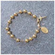 This bracelet has designed by Korea catholic person for her husband. She sugested all destails including cross and miraculous pendant. 24k gold 7mm ball has weaved by 18k solid gold wire of 0.9mm. For the safety reason, 18k gold clasp & 18k gold chain is used. * Material : 24K Solid gold & 18k solid gold *Total weight: about 24gram *24k gold crucifix : 18mm x 11mm *24k gold miraculous medal: 18mm x 11mm *Length: 7-7.5inch (adjustable) please put your actual wrist length then we will arra Spiritual Gold Rosary Bracelet With Gold Beads, Gold Beaded Spiritual Rosary Bracelet, Dainty Handmade Gold Rosary Bracelet, Spiritual Gold Rosary Bracelet, Gold Rosary Bracelet With Gold Beads As A Gift, Adjustable Gold Rosary Bracelet With Miraculous Medal, Gold-plated Rosary Bracelet For Gift, Gold Spiritual Rosary With Round Beads, Yellow Gold Rosary Bracelet With Round Beads