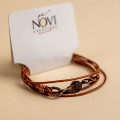 Approx. 14" Handmade in Laurel, Mississippi Beautifully colored natural brown leather with Novi's signature clasp allowing it to snap together with other NoVi bracelets for an original look. Wraps around the wrist twice, or can be worn as a choker. For a looser fit, add an extender! Novi Brown, Rustic Vintage Brown Leather Bracelet, Vintage Distressed Brown Leather Bracelet, Laurel Mississippi, Spiritual Brown Hand-strung Leather Bracelet, Brown Spiritual Leather Bracelet Hand-strung, Brown Hand-strung Spiritual Leather Bracelet, Brown Leather Bracelet, Natural Brown