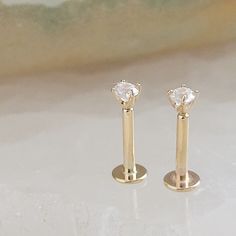 ↘️ Click: "Learn more about this item" for details. Comfortable and easy to wear, these gorgeous diamond CZ studs are set in 14k gold (not plated). Featuring a long tail screw post that makes putting them on super easy! Work, play or sleep, these dainty studs are the perfect everyday accessory. Sold individually or as a pair. * T H E * D E T A I L S *  * Solid 14K Gold, choose form yellow or white * Cubic Zirconia measures 2mm * Post measures 18 gauge and 6mm long * Thoughtfully packaged & ready Internally Threaded 14k Gold Wedding Earrings, 14k Gold Internally Threaded Earrings For Wedding, Screw Posts, White Jewelry Box, Easy Work, Dainty Studs, White Jewelry, Everyday Accessories, Long Tail