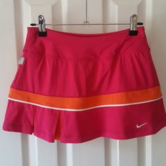 Nwot Gorgeous Fuschia And Orange Nike Dri-Fit Tennis Or Running Skirt. Built In Shorts, Pleats On Side Of Front And Back With Orange Detail Inside. Never Worn, Forgot I Had It. Nike Fitted Tennis Skirt For Spring, Nike Pink Bottoms For Spring, Spring Nike Pink Bottoms, Fitted Nike Skirt, Sporty Pink Skirted Bottoms, Casual Pink Sports Skirt, Casual Pink Skirt For Sports, Sporty Fitted Pink Tennis Skirt, Sporty Pink Fitted Tennis Skirt