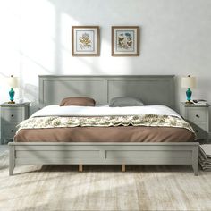 a large bed sitting next to two nightstands in a bedroom