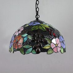 a stained glass light hanging from a chain