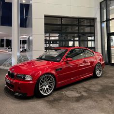 a red car parked in front of a building