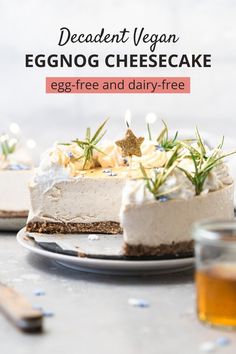 an eggnog cheesecake is on a plate with a glass of tea in the background