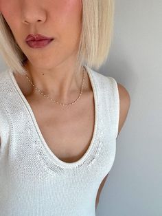 Embrace timeless elegance with our White Mini Pearl Necklace, designed for the modern woman who adores dainty, feminine jewelry. This necklace features an Italian wire-wrapped chain, adjustable from 16 to 18 inches, adorned with delicate 2mm pearl accents throughout. Perfect for layering or wearing alone, this necklace adds a touch of sophistication to any outfit. Whether you're heading to a brunch date or a night out, the White Mini Pearl Necklace is your go-to for effortless, everyday elegance Minimalist Pearl Chain Necklace For Layering, Minimalist Layering Pearl Chain Necklace, Elegant Station Necklace With Satellite Chain, Delicate Pearl Chain Necklace For Layering, Minimalist White Chain Necklace With Delicate Chain, Minimalist White Chain Choker Necklace, Minimalist White Choker Chain Necklace, Minimalist White Delicate Chain Necklace, Gift Pearl Necklace With Satellite Chain