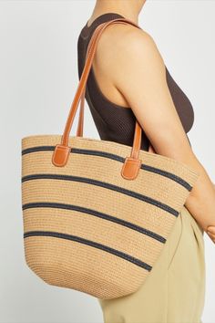 Our Newport Handmade Bag is the perfect choice to add a touch of classic charm to any look. Crafted with an easy tote design and a playful stripe pattern, this handmade bag is the ideal combination of function and style. Everyday Striped Straw Bag, Striped Shoulder Bag With Braided Handles, Striped Rectangular Bag With Braided Handles, Casual Striped Straw Bag, Striped Beach Bag With Braided Handles, Striped Rectangular Straw Bag With Braided Handles, Casual Striped Rectangular Straw Bag, Brown Travel Bag With Striped Lining, Travel Shoulder Bag With Striped Lining