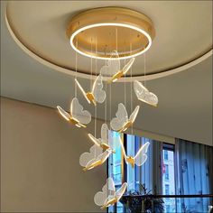 a chandelier hanging from the ceiling in a living room with butterflies on it