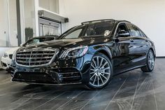 a black car is parked in a showroom