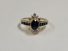 a gold ring with blue and white stones