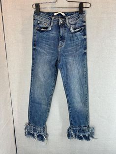 This pair of Zara jeans features a medium wash denim with a worn-in, slightly faded look. The jeans have a classic five-pocket design with visible stitching around the pockets and waist. One of the standout details is the frayed, distressed hem at the ankles, which adds a trendy, casual flair. The overall style is modern and edgy, perfect for a laid-back, fashionable look. * Accept any kind of Payment method through ETSY only- * Please CHECK measurement & photos CAREFULLY. * All sales are FINAL, Denim Flare Jeans With Frayed Hem For Fall, High Rise Denim Jeans With Frayed Hem, Dark Wash High Rise Jeans With Frayed Hem, High-rise Denim Blue Flare Jeans With Frayed Hem, High Rise Denim Blue Flare Jeans With Frayed Hem, Distressed Medium Wash Cropped Denim Jeans, Medium Wash Distressed Denim Jeans, Dark Wash Straight Leg Jeans With Frayed Hem, Distressed Denim Cropped Jeans