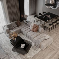 a living room filled with furniture next to a dining room table and window covered in curtains