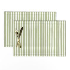 two placemats with forks and spoons on them, one green and white striped napkin