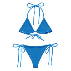 Stay comfortable and beach ready all summer in this FYC String Bikini set. It’s made from soft recycled polyester with double-layering and UPF 50+. Style the straps how you like, and get ready to swim! • Soft and stretchy material with UPF 50+ • Sizes up to 4XL • Bikini top comes with removable padding for comfort • Multiple ways to tie and style the bikini set Disclaimer: To make your All-Over Print Recycled String Bikini last longer, thoroughly rinse it off after each use and get rid of any ch Blue Nylon T-back Swimwear, Adjustable Solid T-back Swimwear, Beach Swimwear With Uv Protection And 4-way Stretch, Adjustable Seamless Solid Swimwear, Adjustable Seamless Nylon Swimwear, Blue Seamless Swimwear With 4-way Stretch, Seamless Nylon Swimwear For Water Sports, Adjustable Blue Nylon Swimwear, Solid Swimwear With Adjustable Straps