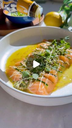 a white bowl filled with food on top of a table