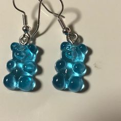 a pair of blue gummy bears dangling from silver ear wires