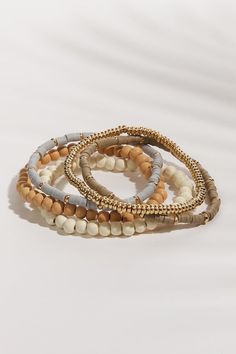 Gold Multi-strand Stackable Bracelets, Gold Stackable Wrap Bracelet For Stacking, Gold Multi-strand Stackable Beaded Bracelets, Everyday Beige Bracelet Jewelry, Gold Multi-strand Beaded Bracelets For Layering, Everyday Gold Multi-strand Bracelets, Stackable Wrap Bracelet For Layering, Bohemian Style Gold Stacked Bracelets, Bohemian Gold Stacked Bracelets