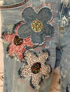 an old pair of jeans with flowers on them