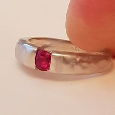 14k white gold ring set with Ruby 14k white Solid Gold Textured Hammered set with 0.24carat natural Burmese ruby 14k 3.3gr. - ruby 0.24c - 980 dolar Product description: Upper part width is- 4.5mm,lower part width - 2.5mm. ruby diameter - 3.8mm Metal 14k solid gold weight 3.3 gr. You can also get this ring : You can get this ring also in 18k gold You can get this ring is Rose Pink and white gold You can set this ring with other stones that suit your style and budget: Diamond, , Emerald, Blue sap Modern White Gold Ruby Ring For Anniversary, Ruby Promise Ring With Round Band, Sterling Silver Open Ruby Ring For Promise, Silver Solitaire Ruby Promise Ring, Classic 14k White Gold Ruby Ring, Modern Ruby Birthstone Ring For Anniversary, Ruby Rings For Promise With Round Band, White Gold Diamond Ring With Ruby, Pink Sapphire Ring With Bezel Setting For Promise