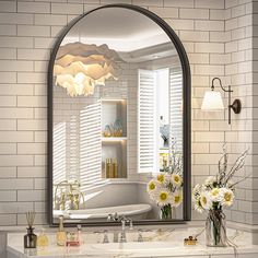 a bathroom with a sink, mirror and flowers in vases