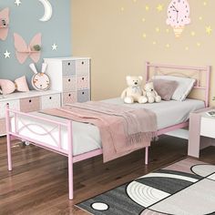 a child's bedroom decorated in pastel pink and white with stars on the wall