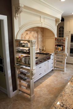 a large kitchen with an oven, stove and cabinets in the middle of the room