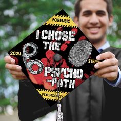 a man holding up a graduation cap that says i chose the psychic path