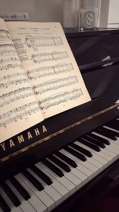 an open book sitting on top of a piano