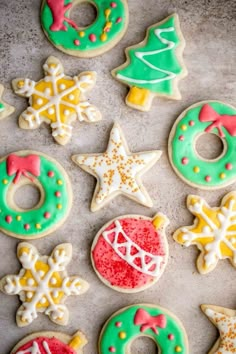 decorated christmas cookies on a baking sheet with frosting and icing decorations around them