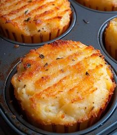 several muffins in a pan with cheese and herbs