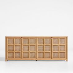 the sideboard is made out of wood and has woven panels on each side, along with