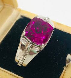 Estate fresh. Gorgeous vintage signed Chuck Clemency STS sterling silver and 2ct pink Quartz solitaire ring. Large sterling silver setting with beautiful 2 carat cushion cut pink quartz. Has lovely braided accents. Setting measures 3/8 inch tall by 3/8 inch wide. Shoulders measure 3/8 inches wide narrowing to 4mm wide at back of band. Ring weighs 7.4 gms and is a size 8. Fully marked and acid tested as sterling silver. All stones tested and guaranteed. Excellent vintage condition with minimal ag Classic Pink Gemstones For Formal Occasions, Formal Pink Ruby Ring In Sterling Silver, Pink Sterling Silver Gemstones For Anniversary, Vintage Pink Hallmarked Rings, Classic Pink Ruby Ring In Sterling Silver, Hallmarked Pink Ruby Ring For Formal Occasions, Vintage Sterling Silver Ruby Ring With Accent Stones, Vintage Pink Jewelry Stamped 925, Pink Quartz Ring