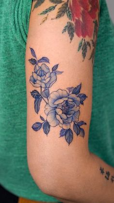 a woman with a flower tattoo on her arm