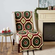 a living room with a fireplace and chair covered in a crocheted blanket next to a fire place