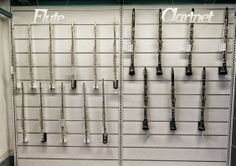 there are many different types of instruments hanging on the wall in this store's display