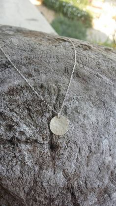 This small sterling silver necklace is perfect for layering! The 12mm solid sterling silver charm is hammered to give a fun effect, and shown here hanging from a 20 inch sterling silver chain, layered on bottom, with our tiny 9mm version in 17 inch length on top. We also have a larger 22mm size available as seen in the triple layer picture. Can also be made in gold fill as seen in the last photo. *Please note that this is for the 12mm disk necklace only. The other sizes are shown for comparison Hammered Sterling Silver Round Pendant, Hammered Sterling Silver Round Pendant Jewelry, Sterling Silver Hammered Jewelry Gift, Hammered Sterling Silver Jewelry For Gifts, Hammered Sterling Silver Jewelry Gift, Hammered Sterling Silver Necklaces In Silver, Everyday Sterling Silver Stamped Necklace, Round Sterling Silver Nickel-free Charm Necklace, Minimalist Stamped 925 Round Pendant Necklace