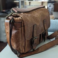 Used But In Good Condition. Brown Leather Camera Bag With Leather Lining, Vintage Cognac Soft Leather Satchel, Classic Brown Leather Camera Bag, Vintage Cognac Satchel With Adjustable Strap, Brown Leather-lined Camera Shoulder Bag, Classic Brown Camera Bag With Adjustable Strap, Classic Brown Rectangular Camera Bag, Vintage Brown Briefcase With Detachable Strap, Classic Brown Camera Bag For Daily Use