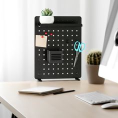 an office desk with a computer and scissors