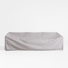 a white couch covered with a sheet on top of it