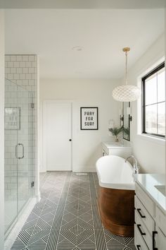 a bathroom with a bathtub, sink and shower in the middle of the room