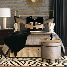 a bedroom with a large bed and black and gold decor