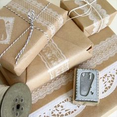 several wrapped presents are sitting on top of a doily next to a sewing machine