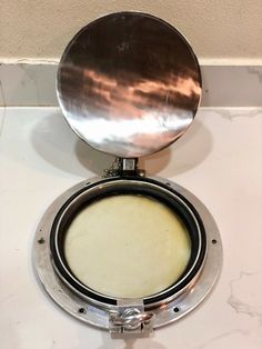 a round mirror sitting on top of a white counter