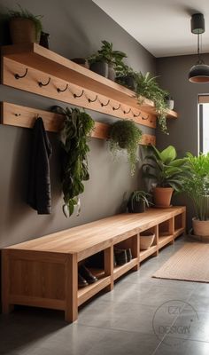 a wooden bench sitting next to a window filled with potted plants