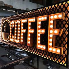 a lighted sign that says coffee with lights on it and the word coffee spelled in large letters