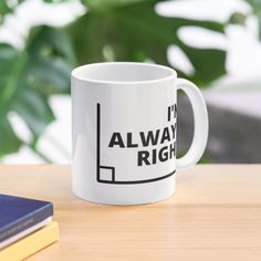 a coffee mug that says i'm always right on the table next to some books