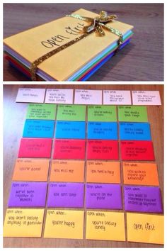 colorful sticky notes with words on them sitting on a wooden floor in front of a laptop